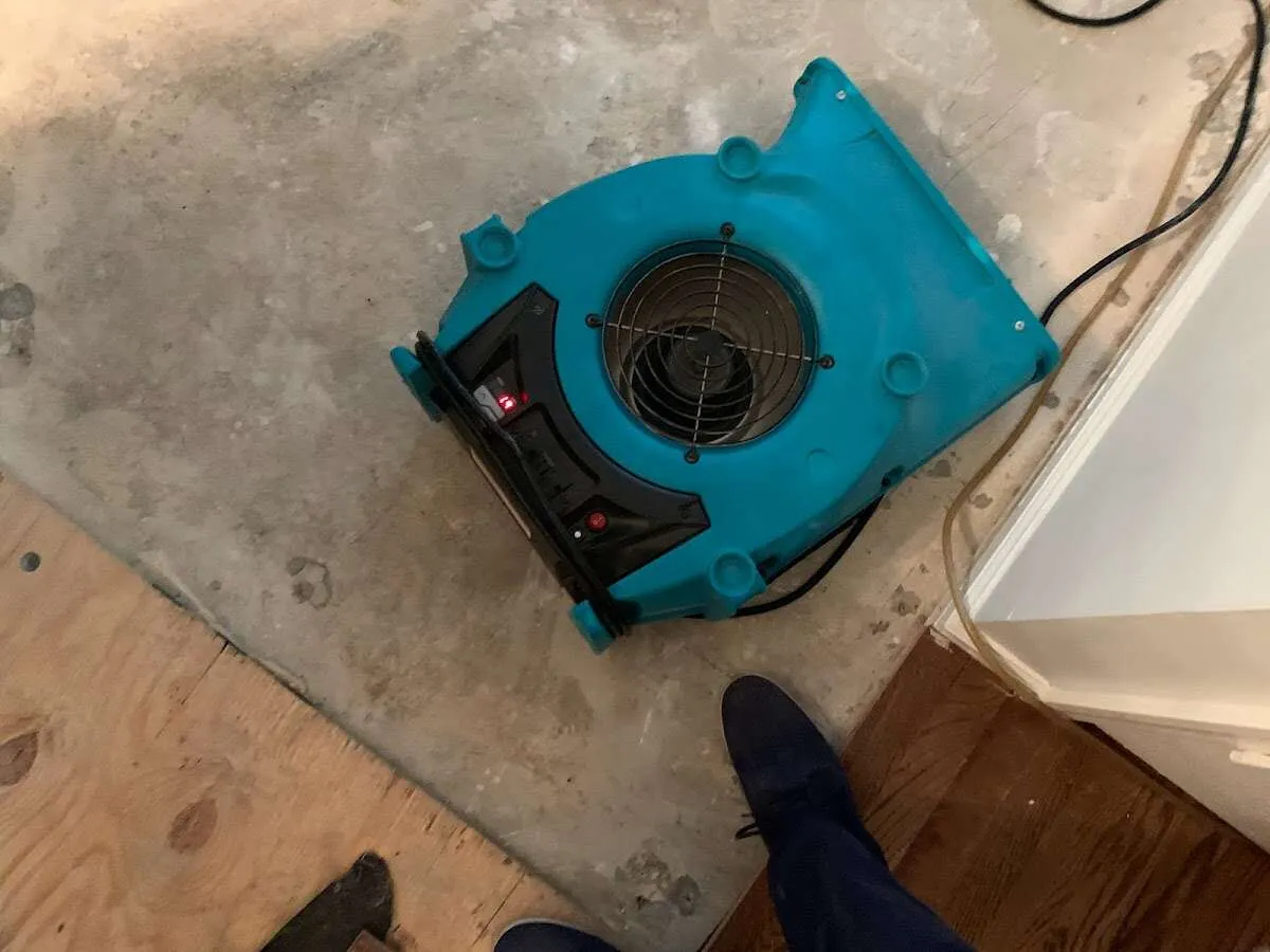 Air mover drying subfloor during Leak Detection & Repair in Vermillion